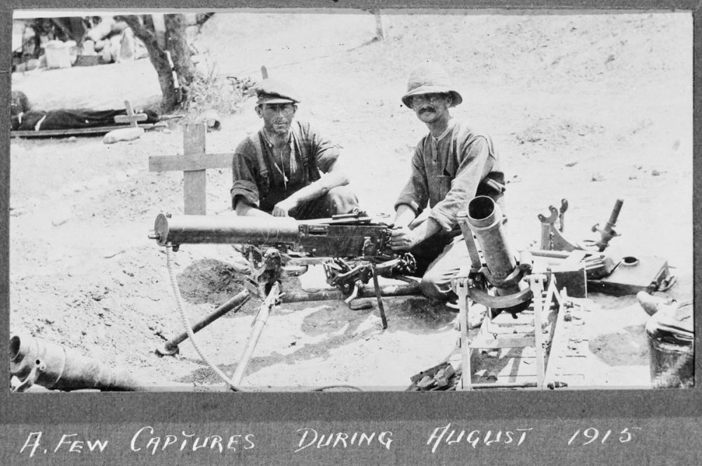 Soldiers with captured weapons - a Vickers machine gun and a mortar, August 1915